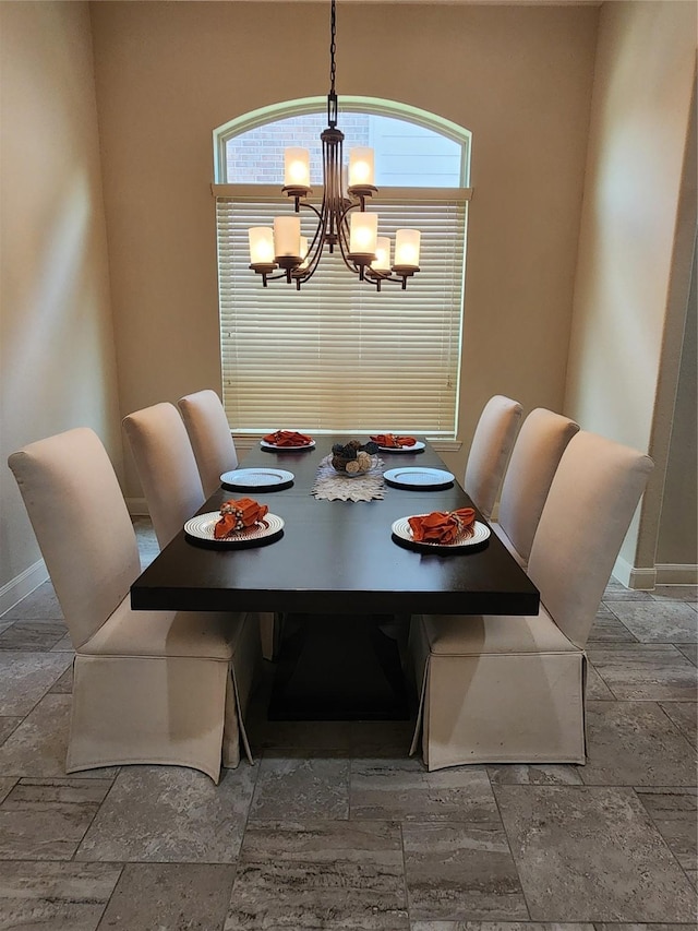 4723 Abercorn St, Rosharon, TX 77583 - dining space with a chandelier, stone tile flooring, and baseboards