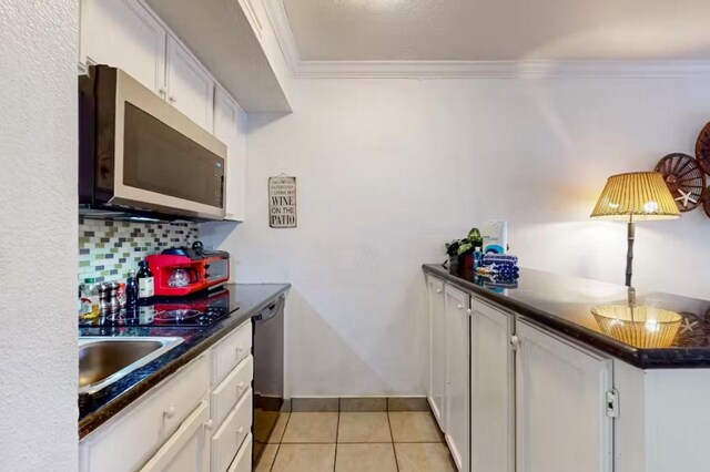 6300 Seawall Blvd Unit 3113, Galveston, TX 77551 - kitchen featuring stainless steel microwave, ornamental molding, dark countertops, a sink, and dishwashing machine