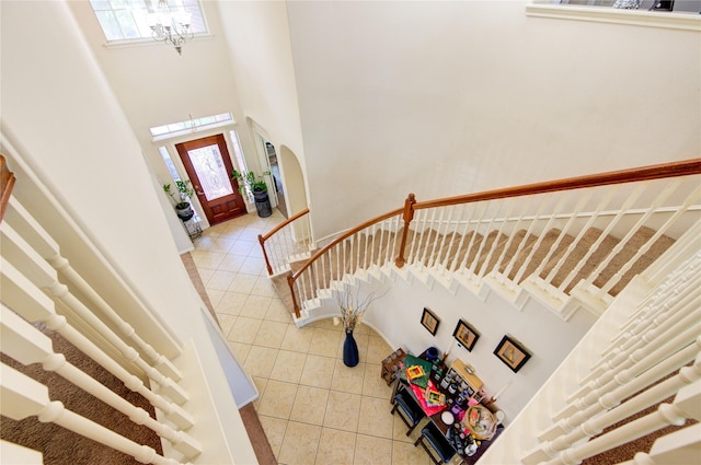 2127 Linden Rock Dr, Katy, TX 77494 - entryway with light tile patterned floors, plenty of natural light, a high ceiling, a chandelier, and stairway