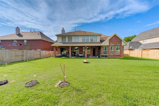 2127 Linden Rock Dr, Katy, TX 77494 - back of property featuring brick siding, a patio, and a chimney
