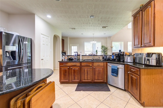 2127 Linden Rock Dr, Katy, TX 77494 - kitchen with appliances with stainless steel finishes, a peninsula, a sink, dark stone countertops, and recessed lighting