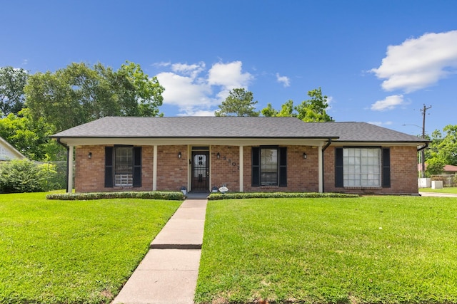 4302 Marchant Rd, Houston, TX 77047 - ranch-style house featuring a front lawn, brick siding, and a porch