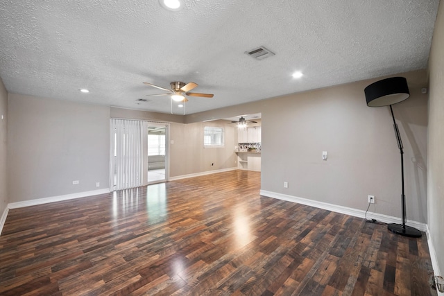 4302 Marchant Rd, Houston, TX 77047 - unfurnished living room featuring a ceiling fan, a textured ceiling, wood finished floors, baseboards, and recessed lighting