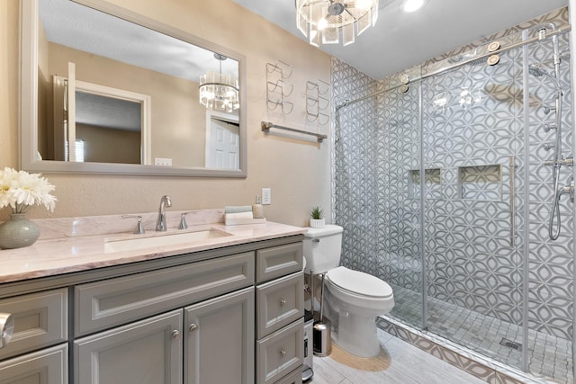 4302 Marchant Rd, Houston, TX 77047 - full bathroom with a chandelier, a stall shower, toilet, vanity, and tile patterned flooring