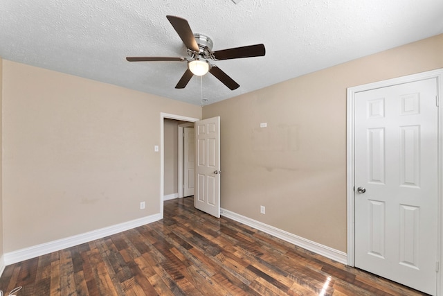 4302 Marchant Rd, Houston, TX 77047 - unfurnished bedroom with dark wood-type flooring, baseboards, a textured ceiling, and ceiling fan
