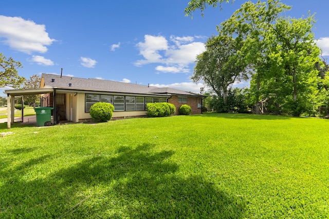 4302 Marchant Rd, Houston, TX 77047 - view of green lawn featuring an attached carport