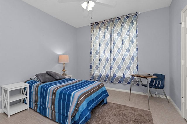 bedroom with light tile patterned floors, baseboards, and ceiling fan