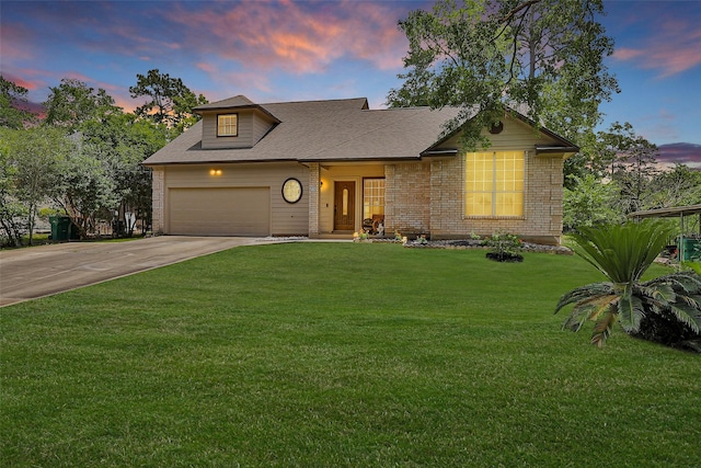 view of front of property with concrete driveway, an attached garage, a front yard, brick siding, and a shingled roof