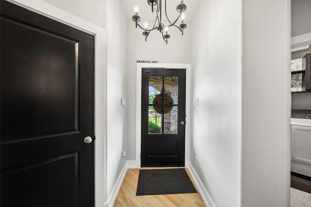 19266 Hazel Firs Ct, Magnolia, TX 77355 - foyer with wood finished floors, a chandelier, washer / dryer, and baseboards