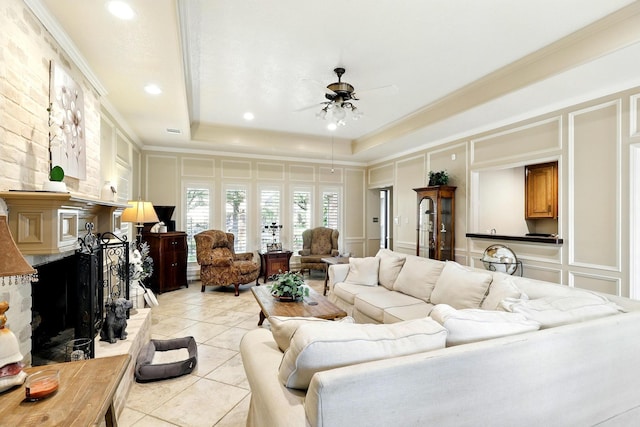 17714 Treeloch Ln, Spring, TX 77379 - living area with a decorative wall, ceiling fan, light tile patterned floors, crown molding, and a tray ceiling