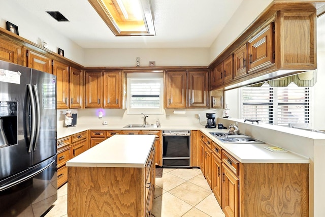 17714 Treeloch Ln, Spring, TX 77379 - kitchen with stainless steel appliances, a sink, light countertops, light tile patterned flooring, and brown cabinetry