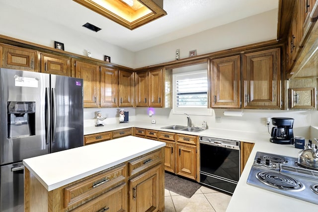 17714 Treeloch Ln, Spring, TX 77379 - kitchen with stainless steel appliances, light countertops, a sink, light tile patterned flooring, and brown cabinetry