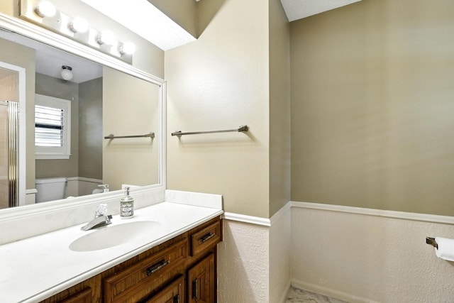 17714 Treeloch Ln, Spring, TX 77379 - bathroom with vanity, toilet, an enclosed shower, and wainscoting