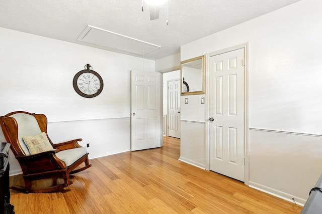 17714 Treeloch Ln, Spring, TX 77379 - living area with attic access, light wood finished floors, baseboards, and a ceiling fan