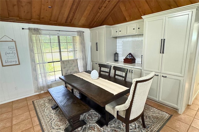 3428 S Main St, Anahuac, TX 77514 - dining area with wood ceiling, vaulted ceiling, light tile patterned flooring, and wood walls