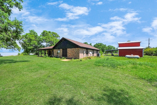 3428 S Main St, Anahuac, TX 77514 - view of green lawn featuring an outbuilding and a pole building