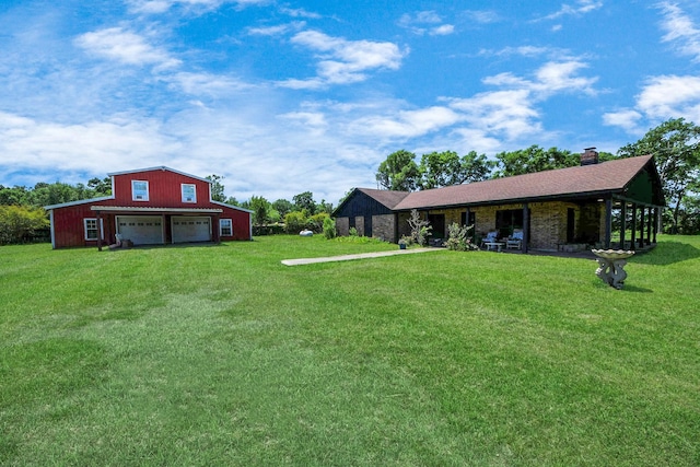 3428 S Main St, Anahuac, TX 77514 - view of green lawn with a garage