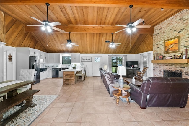 3428 S Main St, Anahuac, TX 77514 - living area with ceiling fan, wooden ceiling with exposed beams, light tile patterned floors, a fireplace, and high vaulted ceiling