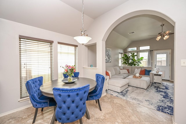 10911 Overland Trail Dr, Richmond, TX 77406 - dining space with lofted ceiling, arched walkways, ceiling fan, tile patterned flooring, and baseboards