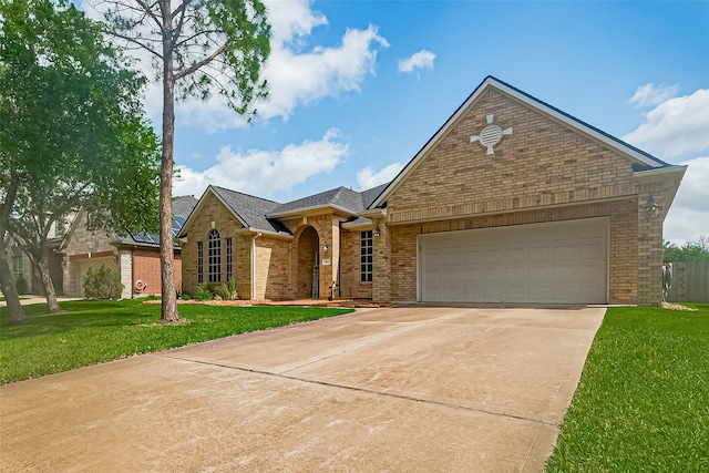 13903 Autumn Grove Ct, Rosharon, TX 77583 - view of front of house featuring brick siding, concrete driveway, an attached garage, and a front yard