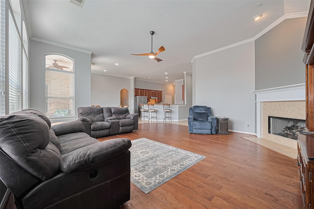 13903 Autumn Grove Ct, Rosharon, TX 77583 - living room with a ceiling fan, ornamental molding, a fireplace, light wood-style flooring, and recessed lighting