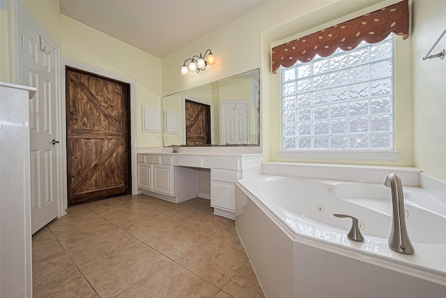 13903 Autumn Grove Ct, Rosharon, TX 77583 - bathroom with vanity, a jetted tub, and tile patterned floors