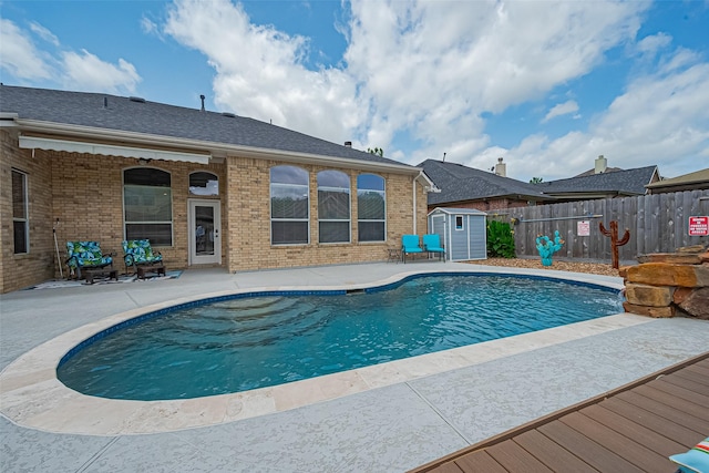 13903 Autumn Grove Ct, Rosharon, TX 77583 - view of swimming pool with a storage shed, a patio, a fenced backyard, and an outdoor structure