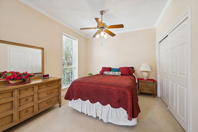 311 Pineview Cir, El Lago, TX 77586 - bedroom featuring light carpet, ornamental molding, a closet, and a ceiling fan