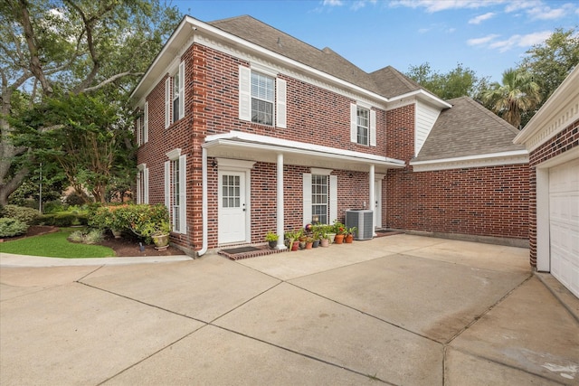 311 Pineview Cir, El Lago, TX 77586 - view of front of house featuring brick siding, driveway, central air condition unit, and a shingled roof