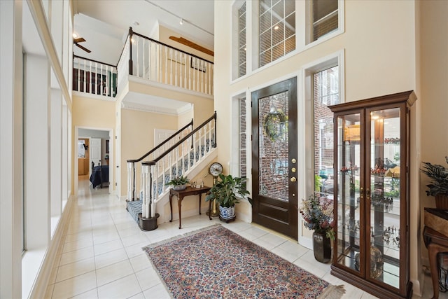 311 Pineview Cir, El Lago, TX 77586 - tiled foyer featuring a towering ceiling, stairway, and a ceiling fan