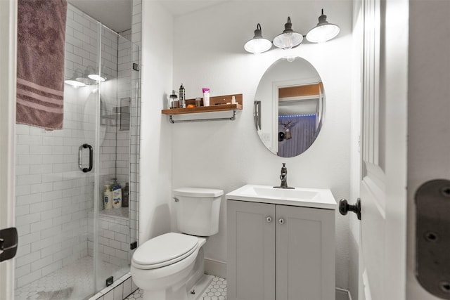 full bathroom with a stall shower, toilet, vanity, tile patterned floors, and baseboards