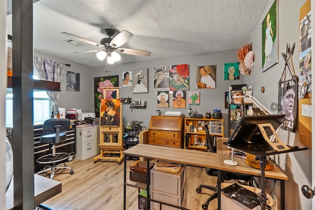 home office with ceiling fan, wood finished floors, and a textured ceiling