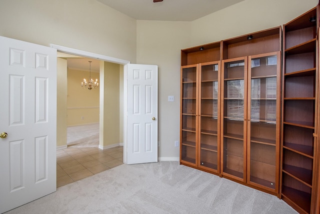 7218 Welshwood Ln, Sugar Land, TX 77479 - unfurnished bedroom featuring a chandelier, carpet flooring, tile patterned flooring, and baseboards