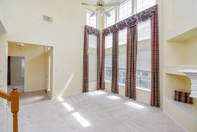 7218 Welshwood Ln, Sugar Land, TX 77479 - spare room featuring a towering ceiling, plenty of natural light, carpet floors, ceiling fan, and baseboards