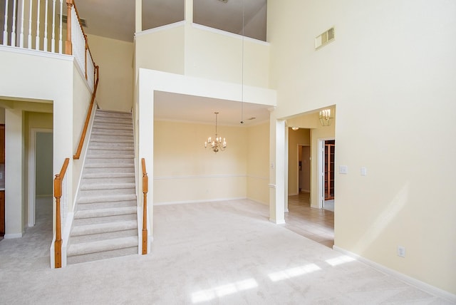 7218 Welshwood Ln, Sugar Land, TX 77479 - stairs featuring a towering ceiling, a chandelier, carpet flooring, and baseboards