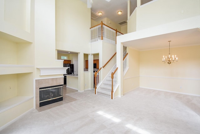 7218 Welshwood Ln, Sugar Land, TX 77479 - unfurnished living room featuring stairway, light colored carpet, a fireplace, a chandelier, and baseboards