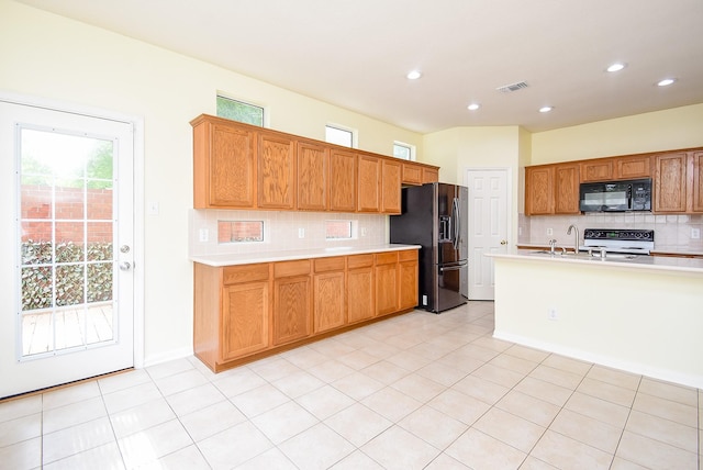 7218 Welshwood Ln, Sugar Land, TX 77479 - kitchen featuring black microwave, fridge with ice dispenser, electric range oven, light countertops, and backsplash