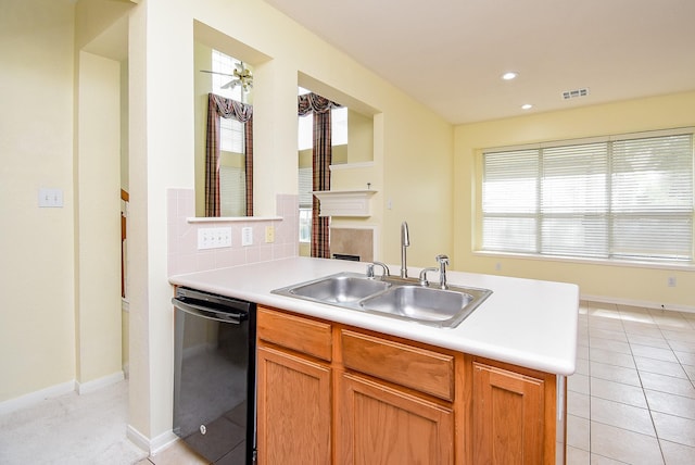 7218 Welshwood Ln, Sugar Land, TX 77479 - kitchen with black dishwasher, a sink, light countertops, plenty of natural light, and recessed lighting