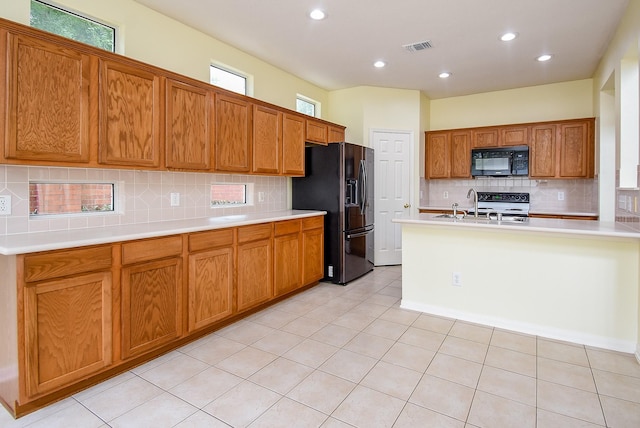 7218 Welshwood Ln, Sugar Land, TX 77479 - kitchen featuring black appliances, tasteful backsplash, light countertops, recessed lighting, and a sink