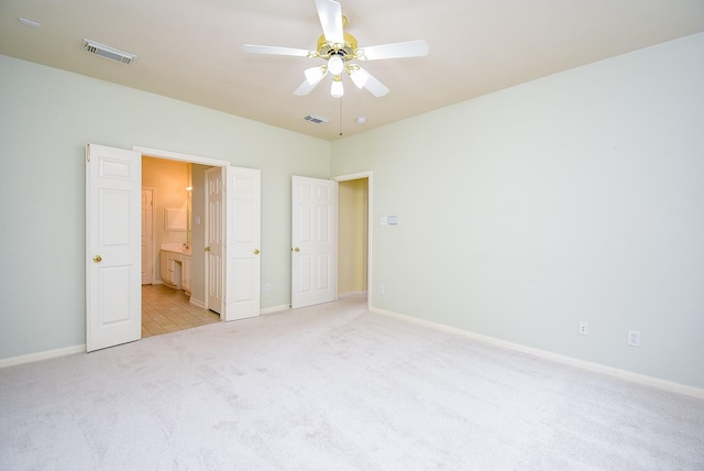7218 Welshwood Ln, Sugar Land, TX 77479 - unfurnished bedroom featuring light colored carpet, baseboards, ensuite bathroom, and a ceiling fan