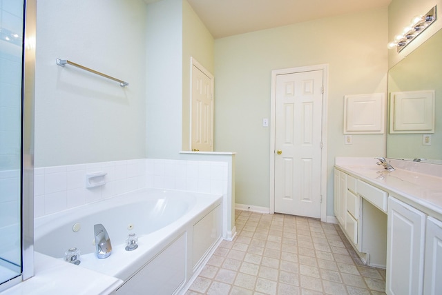 7218 Welshwood Ln, Sugar Land, TX 77479 - full bath with a tub with jets, vanity, and baseboards