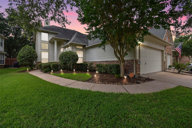 7218 Welshwood Ln, Sugar Land, TX 77479 - view of front of house featuring a front yard, driveway, an attached garage, a shingled roof, and stone siding