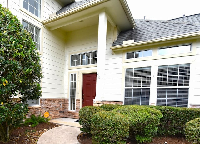 7218 Welshwood Ln, Sugar Land, TX 77479 - property entrance featuring a shingled roof and stone siding