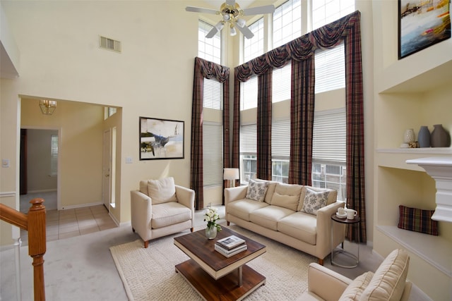 7218 Welshwood Ln, Sugar Land, TX 77479 - tiled living room with a towering ceiling, ceiling fan, carpet flooring, baseboards, and a chandelier