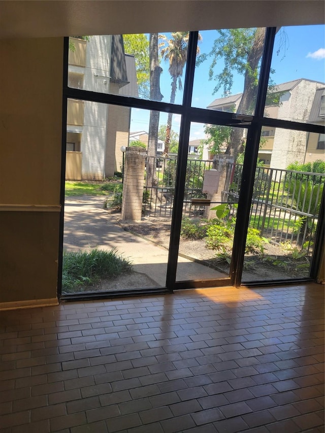 8425 Hearth Dr Unit 25, Houston, TX 77054 - doorway featuring healthy amount of natural light and baseboards