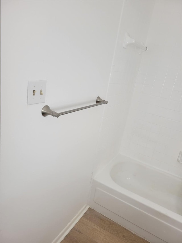 8425 Hearth Dr Unit 25, Houston, TX 77054 - bathroom with wood finished floors, bathtub / shower combination, and baseboards