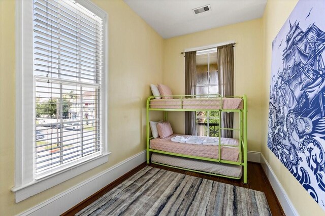 1427 Winnie St, Galveston, TX 77550 - bedroom featuring wood finished floors, multiple windows, and baseboards