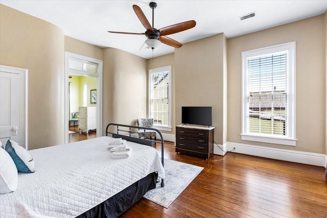 1427 Winnie St, Galveston, TX 77550 - bedroom with hardwood / wood-style floors, baseboards, ceiling fan, and baseboard heating