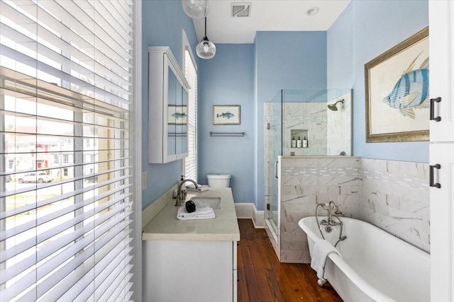 1427 Winnie St, Galveston, TX 77550 - bathroom with a stall shower, a freestanding bath, hardwood / wood-style flooring, and vanity