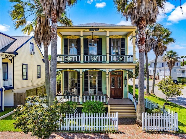 1427 Winnie St, Galveston, TX 77550 - view of front of property with a porch, a balcony, and a fenced front yard